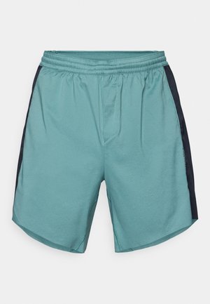 Light teal athletic shorts with an elastic waistband, featuring dark blue side panels and a smooth, breathable fabric texture.