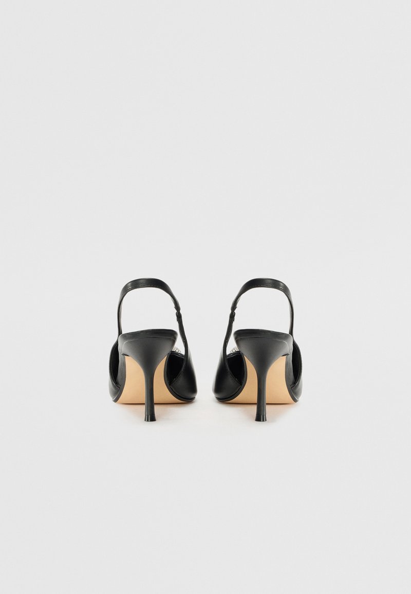Czarne skórzane szpilki typu slingback z szpiczastym noskiem i smukłym obcasem typu stiletto. Gładka textura i minimalistyczny design z brązową wkładką.