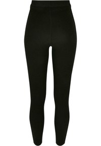 Svart ribbede leggings med høy livlinje, en tettsittende fasong og en teksturert stoff, designet for komfort og allsidighet.