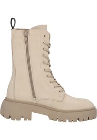 Botines beige con cordones y cremallera lateral, fabricados en material de ante. Suela de goma gruesa con textura estriada para un buen agarre.