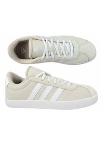 Sneakers beige con accenti bianchi, realizzati in materiale scamosciato, con punta rotonda e design a tre strisce sui lati. Suola piatta in gomma bianca.