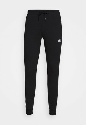 Mustad puuvillasegust mustad dressipüksid, elastse vöökoha ja nööriga, kitsenevad sääred ja valged aksendijoone. Adidas logo ees.