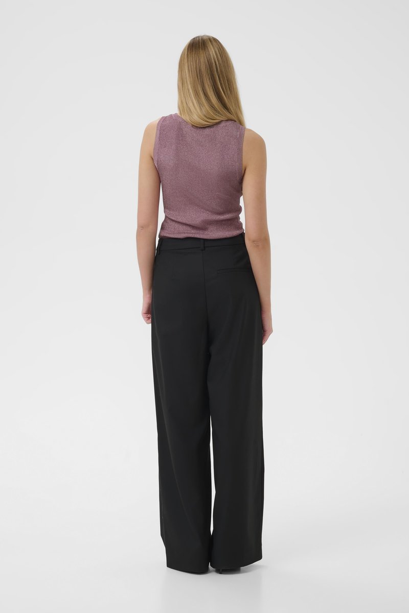 Light purple sleeveless top with a textured surface paired with high-waisted black wide-leg pants. Simple, minimalistic design.