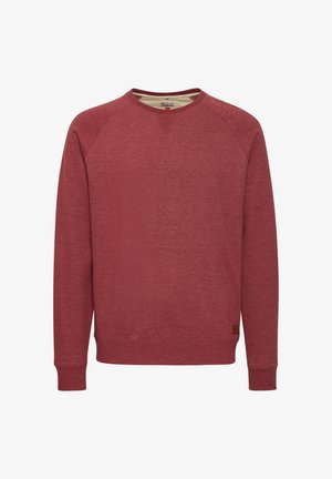 Punane kapuutsi särk, mis on valmistatud pehmest tekstuuriga kangast. Omab ümmargust kaelust, pikki raglanvarrukaid ja külje peal on väike pruun logo silt.