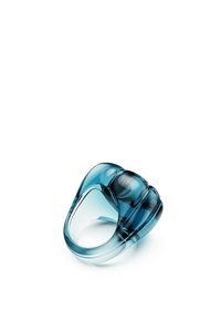 Translucent blue acrylic ring with smooth, rounded edges and a sculptural design. Notable for its layered, curved shape and glossy finish.