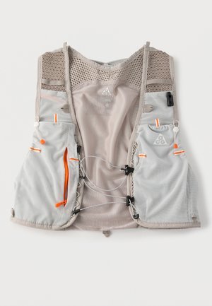 Light gray mesh running vest with orange zipper pulls, adjustable cords, and multiple front pockets, designed for breathability and storage.