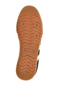 Suola di scarpa in gomma con un motivo a zigzag, dotata di un logo crema e della stampa della taglia "42". Parte superiore di un blu scuro visibile.