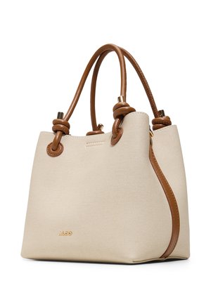 Cream-colored tote bag with brown leather handles featuring knot details and gold hardware, branded with small ALDO logo on front.