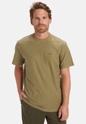 Olive green short-sleeve t-shirt made of lightweight, textured fabric. Features a small logo on the chest and a round neckline.