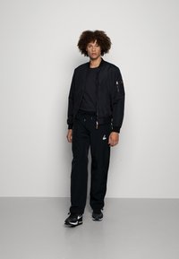 Jordan WARMUP PANT - Calças de fato de treino - black