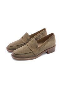 Brown suede loafers with a flat heel, featuring a decorative band across the vamp and a smooth rubber sole. Classic, understated design.