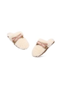 Cream-colored fur slippers with a textured surface, featuring a decorative strap with red and white zigzag patterns and a brown base.