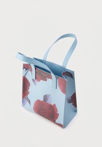 Blue, floral print tote bag with red roses and green leaves. Features dual flat handles and a structured shape. Smooth texture.