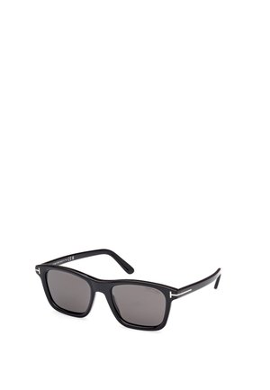 Black rectangular sunglasses with dark lenses, plastic frame, and silver accents on the arms. Minimalist design with smooth texture.