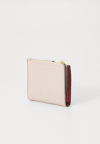 Pink leather wallet with a textured finish, featuring a gold zipper, contrasting red interior, and stitched edges for added detail.
