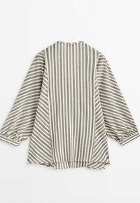 Blouse à manches longues, coupe ample, avec des rayures verticales et diagonales beige et marron, des poignets légèrement évasés et un col rond.