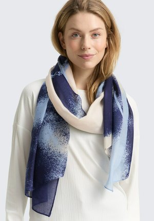 Écharpe légère au design dégradé, présentant des couleurs marine, bleu clair et crème. Texture douce avec des motifs abstraits tout au long.