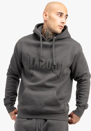 Gray hoodie featuring a large, black "TAPOUT" logo on the front. It has a drawstring hood, front pocket, and ribbed cuffs and hem.