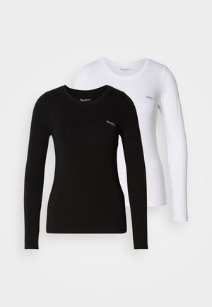 T-shirt a maniche lunghe in bianco e nero realizzate in cotone morbido. La maglietta nera presenta un collo tondo e entrambe hanno un piccolo logo sul petto.