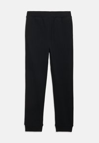 Black sweatpants made of soft fabric, featuring an elastic waistband, tapered legs, and elastic cuffs. No visible pockets or patterns.