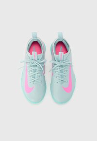 Light blue athletic shoes with pink accents, featuring textured material, a rounded toe, and flat laces. Sole has grip pattern.