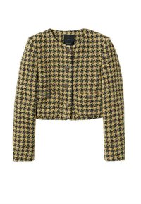 Keltainen ja musta tweed-tyylinen lyhyt takki, jossa on pitkät hihat, pyöreä kaula-aukko ja etupainikkeet, joissa on teksturoitu houndstooth-kuvio.
