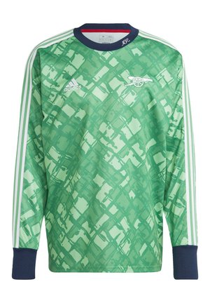 Maillot de sport vert à manches longues avec motif abstrait, col et poignets bleu marine, logo Adidas blanc, emblème de canon et bandes blanches Adidas sur les manches.
