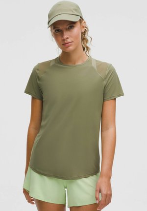 Olive green athletic shirt with short sleeves and a round neck, featuring transparent mesh accents on the shoulders.
