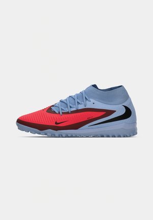 Blue and red Nike athletic shoe with high ankle collar, textured toe, lace-up design, and black swoosh logo on side, shown in profile.