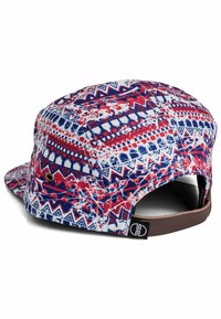 Cap made of patterned fabric featuring red, blue, and white geometric designs. Short visor with a brown adjustable strap at the back.