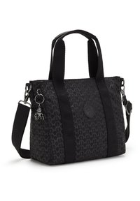 Black tote bag made of patterned fabric, featuring sturdy handles, a detachable strap, and a silver charm attached.