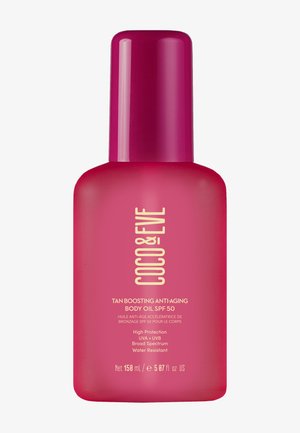 Helle pinke Flasche mit "Coco & Eve" Tan-Boosting Anti-Aging Körperöl mit SPF 50, das Produktdetails und Nettovolumen auf dem Etikett zeigt.