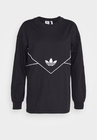 Black long-sleeve shirt with white outlined chevron and Adidas trefoil logo centered on the chest against a plain background.
