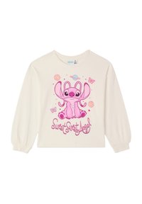 Camicia a maniche lunghe color crema con un personaggio dei cartoni animati rosa con grandi orecchie, circondato da pianeti e farfalle, con il testo "Dolce Dolce Angelo".