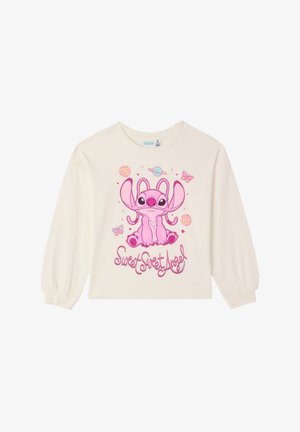 Camicia a maniche lunghe color crema con un personaggio dei cartoni animati rosa con grandi orecchie, circondato da pianeti e farfalle, con il testo "Dolce Dolce Angelo".