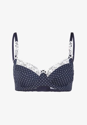Navy blue bra with white polka dots, lace trim along the top, adjustable straps, and a hook-and-eye closure at the back.