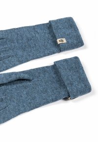 Blue knitted gloves with folded cuffs and small rectangular beige tags sewn on the side near the wrist.