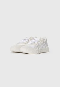 White athletic sneakers with textured panels, a chunky sole, and lace-up design. Features subtle grey accents and a padded collar.