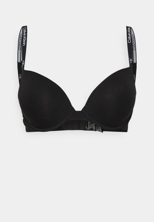 Black padded bra with smooth cups, signature branded straps, and a hook-and-eye closure. Made from soft, stretch fabric for comfort.