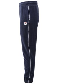 Marina blå sammetsträningbyxor med elastisk midja, vita sidostråk och en liten broderad logotyp på övre låret. Slät textur.