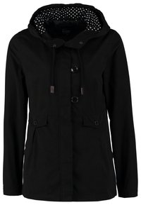 Veste noire à capuche avec boutons sur le devant, capuche avec cordon et doublure blanche à pois, et deux poches à rabat avec boutons.