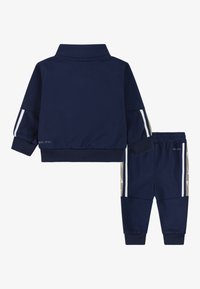 Nike Sportswear CLUB PROPUS UNISEX SET - Pantaloni de trening - midnight navy