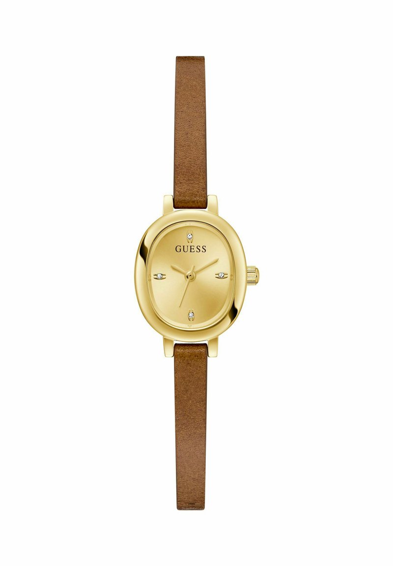 Montre analogique dorée avec un cadran ovale, bracelet en cuir marron et accents en cristal sur le cadran. Index horaires simples et couronne.