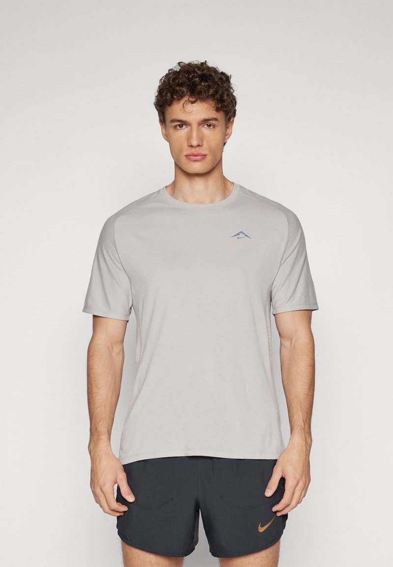 Light gray short-sleeve t-shirt with a subtle blue logo on the chest, featuring a crew neck and a relaxed fit. Soft, smooth fabric.