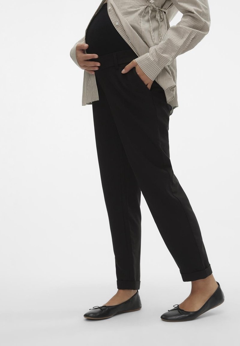 Black maternity trousers with a straight fit, featuring a flat front, side pockets, and rolled cuffs. Paired with a striped shirt and flats.