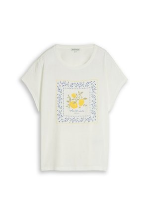 T-shirt blanc à manches courtes avec col rond, présentant un motif de citron et feuille encadré par des branches bleues et le texte "Dolce far niente."