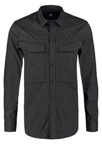 Camicia nera con bottoni, caratterizzata da maniche lunghe, due tasche frontali e una texture liscia. Realizzata in un tessuto leggero e resistente.