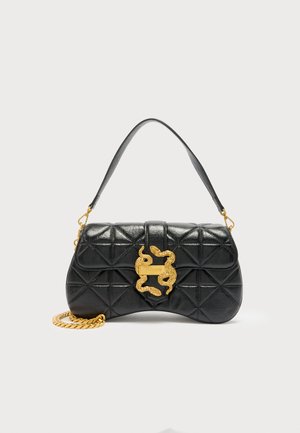 Black quilted leather handbag with curved shape, gold snake-shaped clasp, short leather strap, and gold chain detail.