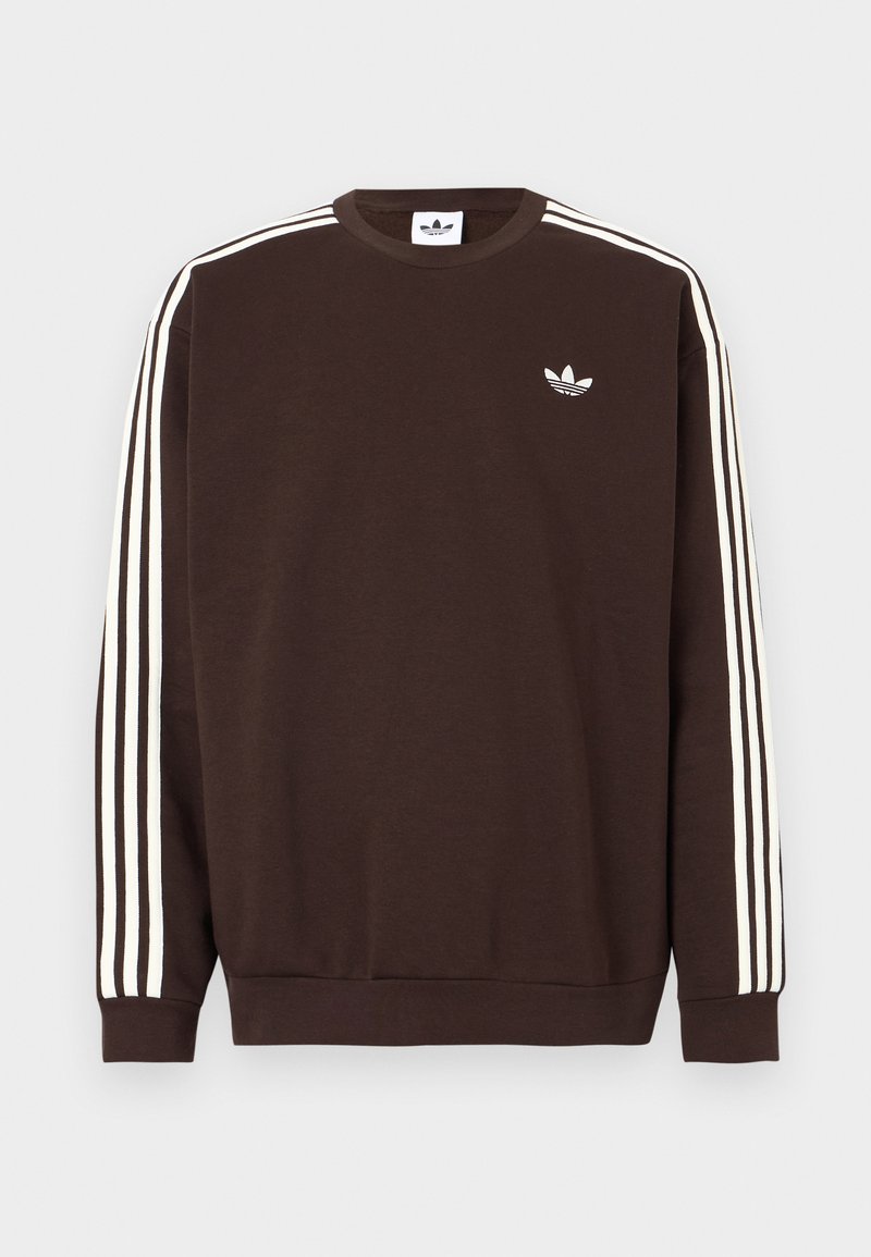 Felpa Adidas marrone scuro con tre strisce bianche lungo le maniche e logo trefoil Adidas bianco sul petto.