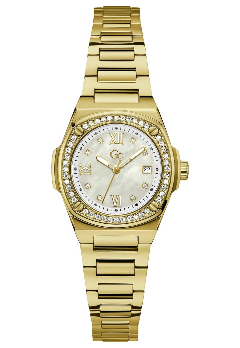 Guldmetallklocka med en urtavla av pärlemor och kristalldetaljer. Har en rund urtavla, romerska siffror och en datumvisning.